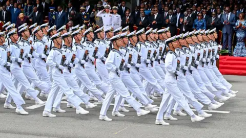     Sia Kamboo / AFP Gambar parade Angkatan Bersenjata Tiongkok saat perayaan 64 tahun kemerdekaan Pantai Gading di kota resor Grand-Bassam, Pantai Gading - Rabu 7 Agustus 2024