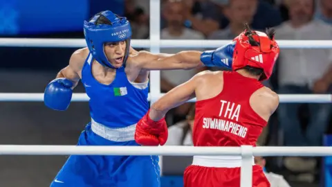 Imane Khalif melayangkan pukulan ke Janjem Suwannafeng di Thailand pada 6 Agustus 2024 oleh Aytak Unal/Getty Images.