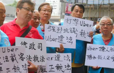 Getty Images Pengemudi taksi Hong Kong melakukan protes di luar kantor pusat Uber di Causeway Bay