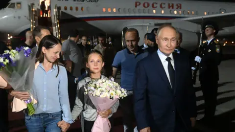 Presiden EPA Vladimir Putin menyambut para tahanan Rusia yang dibebaskan di landasan 