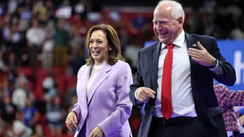 AFP Kamala Harris (Kiri) dan Gubernur Minnesota Tim Walz memberi isyarat saat kampanye di Las Vegas, Nevada