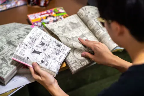 Getty Seorang remaja Jepang membaca banyak salinan manga One Piece