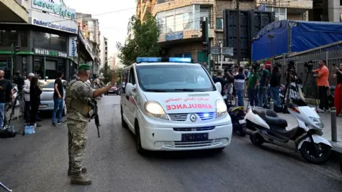 EPA Seorang tentara Lebanon menunjuk ke arah ambulans di Beirut (17/09/24)