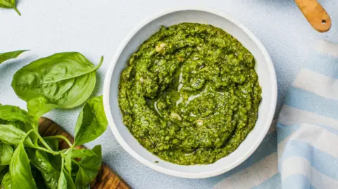 Getty Images Semangkuk pesto segar dengan kacang pinus, basil, bawang putih, minyak, dan parmesan