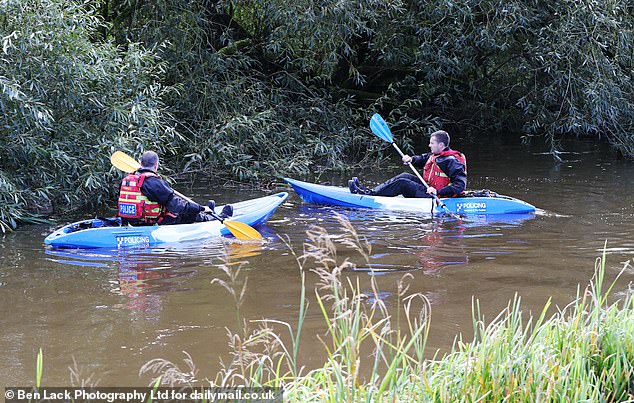 Dua polisi terlihat menggeledah Sungai Derwent dengan kayak pada hari Jumat