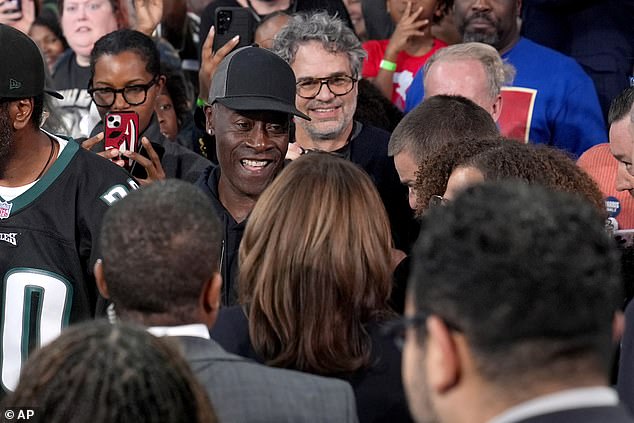 Calon Wakil Presiden dari Partai Demokrat Kamala Harris, tengah bawah, menyapa aktor 'Avengers' Don Cheadle, kiri tengah atas, dan Mark Ruffalo, kanan tengah atas, setelah berbicara dalam rapat umum komunitas